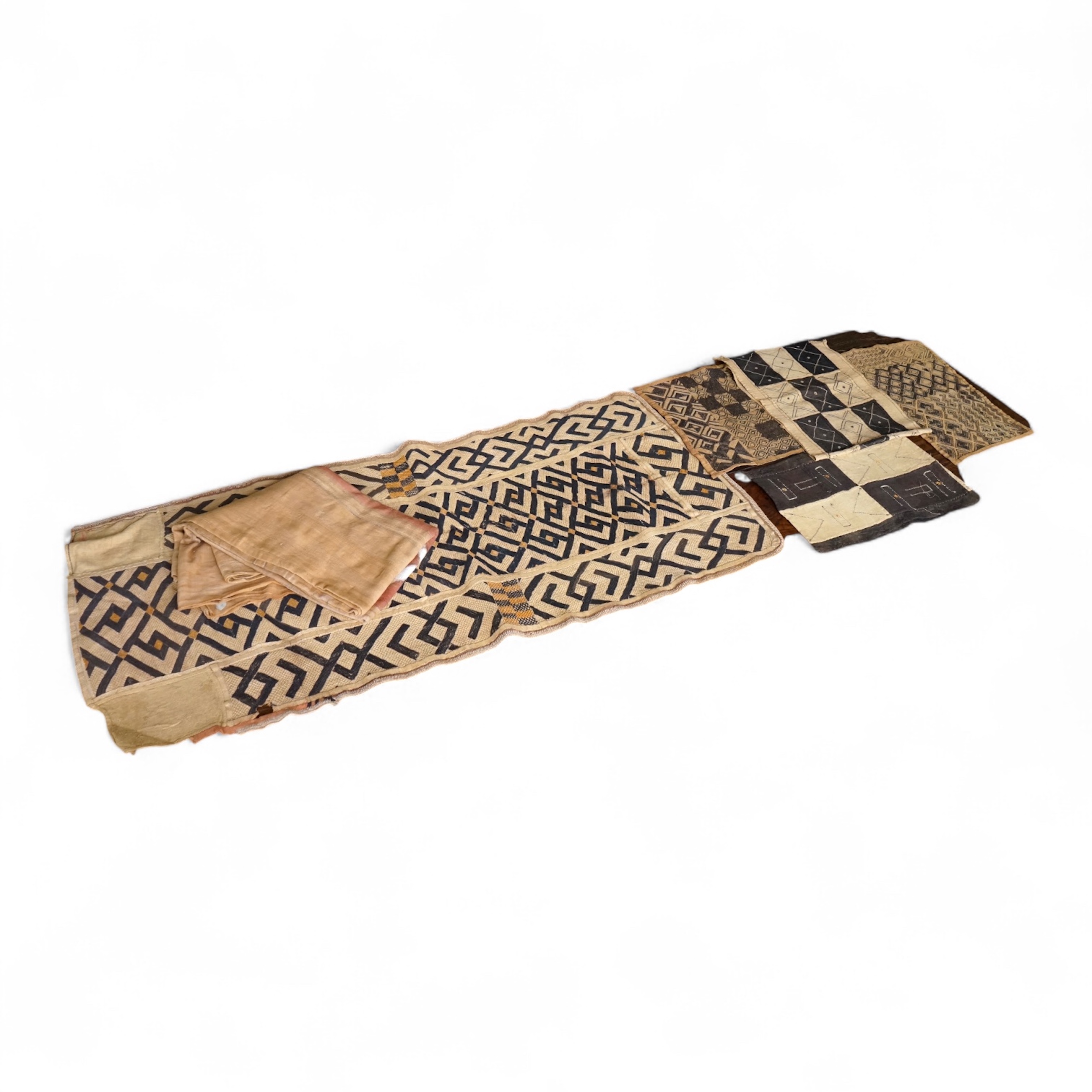 A collection of five 20th century African Congo hand woven and embroidered raffia palm leaf runners and mats, together with a later large printed hanging. 260cm x 138cm. Condition - one smaller mat has a hole in the weav